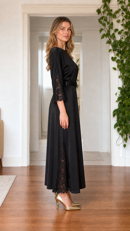 Side view of model wearing black satin maxi dress showing lace sleeve and skirt detail