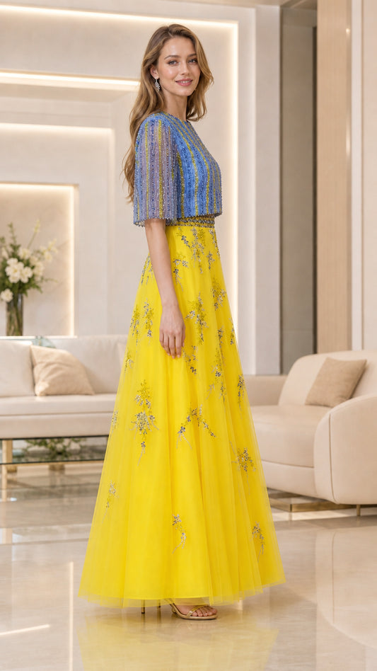 Side-angle view of model in yellow and blue flutter-sleeve embellished maxi dress
