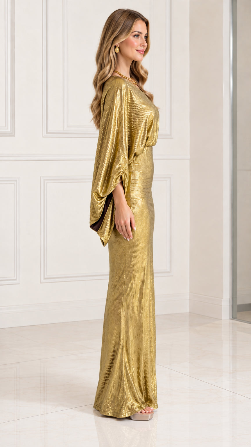 Side view of gold metallic draped maxi dress showing silhouette and drape