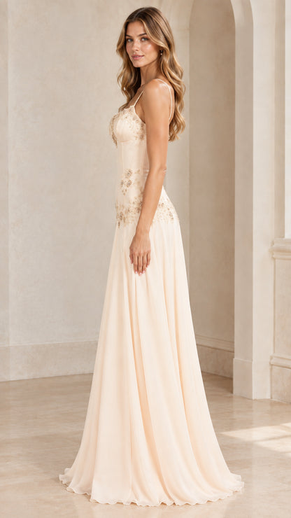 Side profile of champagne embroidered A-line formal gown with spaghetti straps