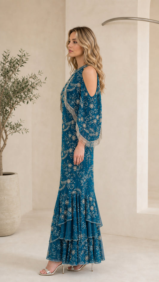 Side profile of model in Teal Blue beaded fringe capelet gown showing silhouette