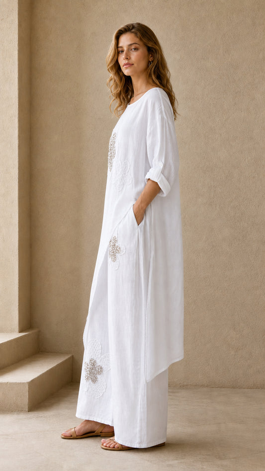 Model wearing white two piece tunic and wide leg pants set - side angled view