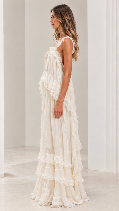 Side angle of woman in flowy ivory bohemian tiered maxi dress