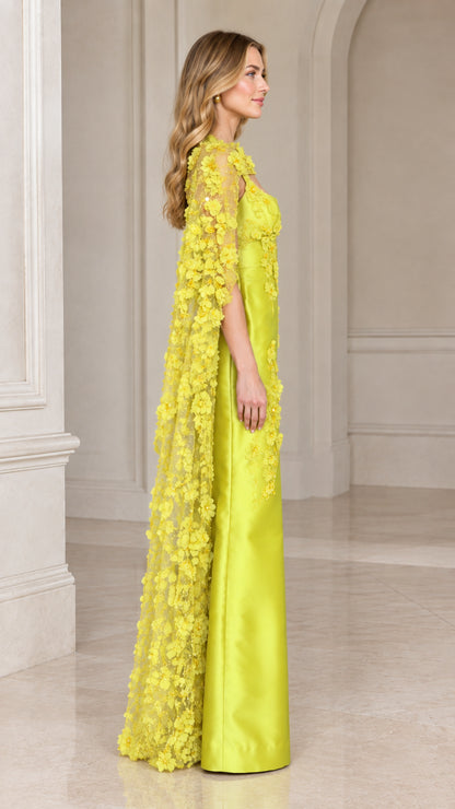 Side profile view of lime green floor-length cape evening gown