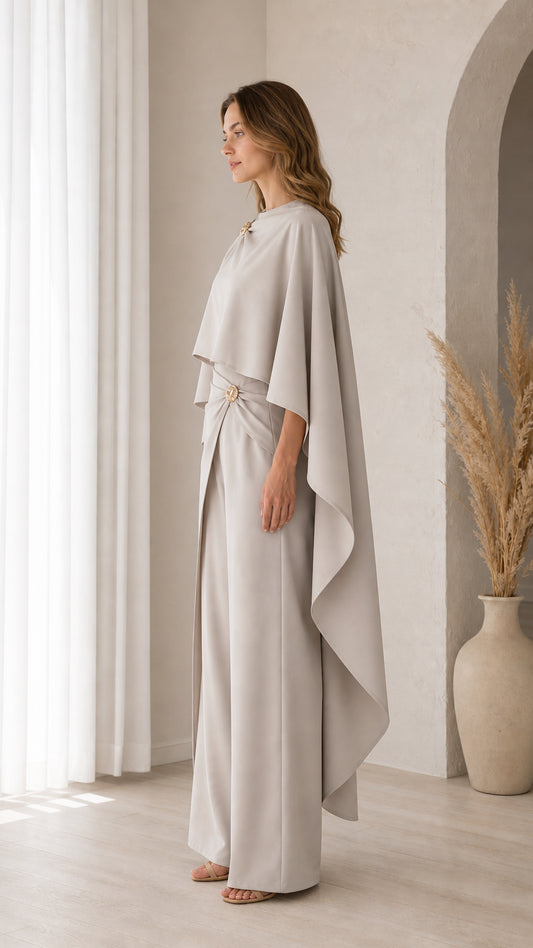 Side profile view of model in Light Grey draped cape top and floor-length trousers