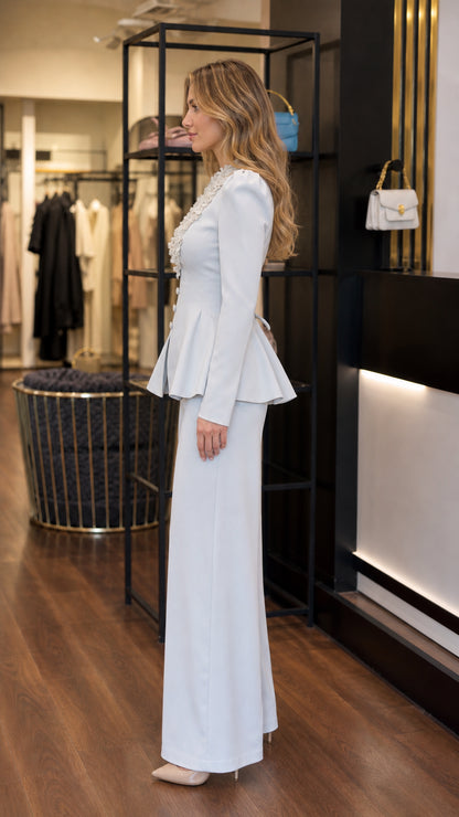 Side view of light blue tailored peplum blazer and wide leg trousers