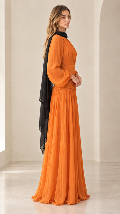 Side profile view of orange long sleeve evening gown