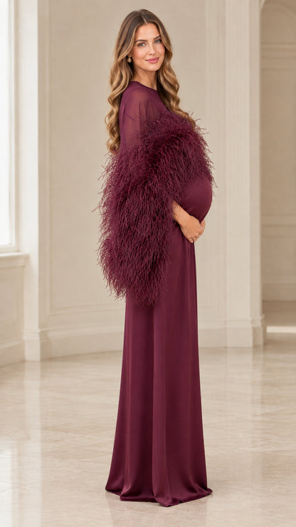 Side view of pregnant woman wearing burgundy feather trimmed gown