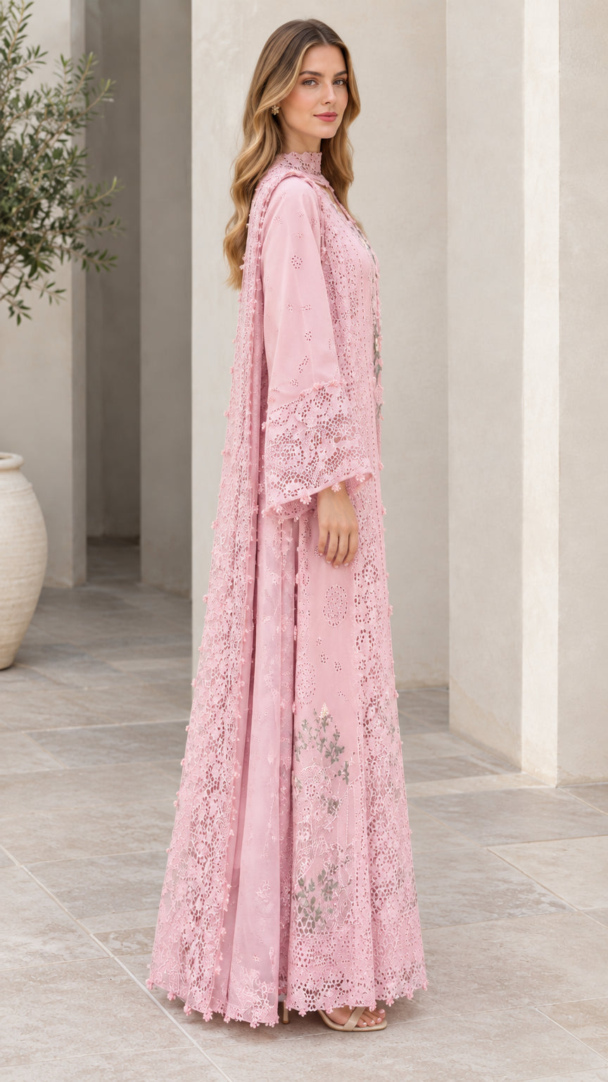 Side angle view of blush pink floral embroidered lace gown showing drape and silhouette