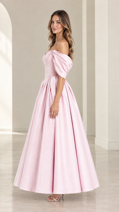 Side angle view of model in Blush Pink off-shoulder satin midi gown