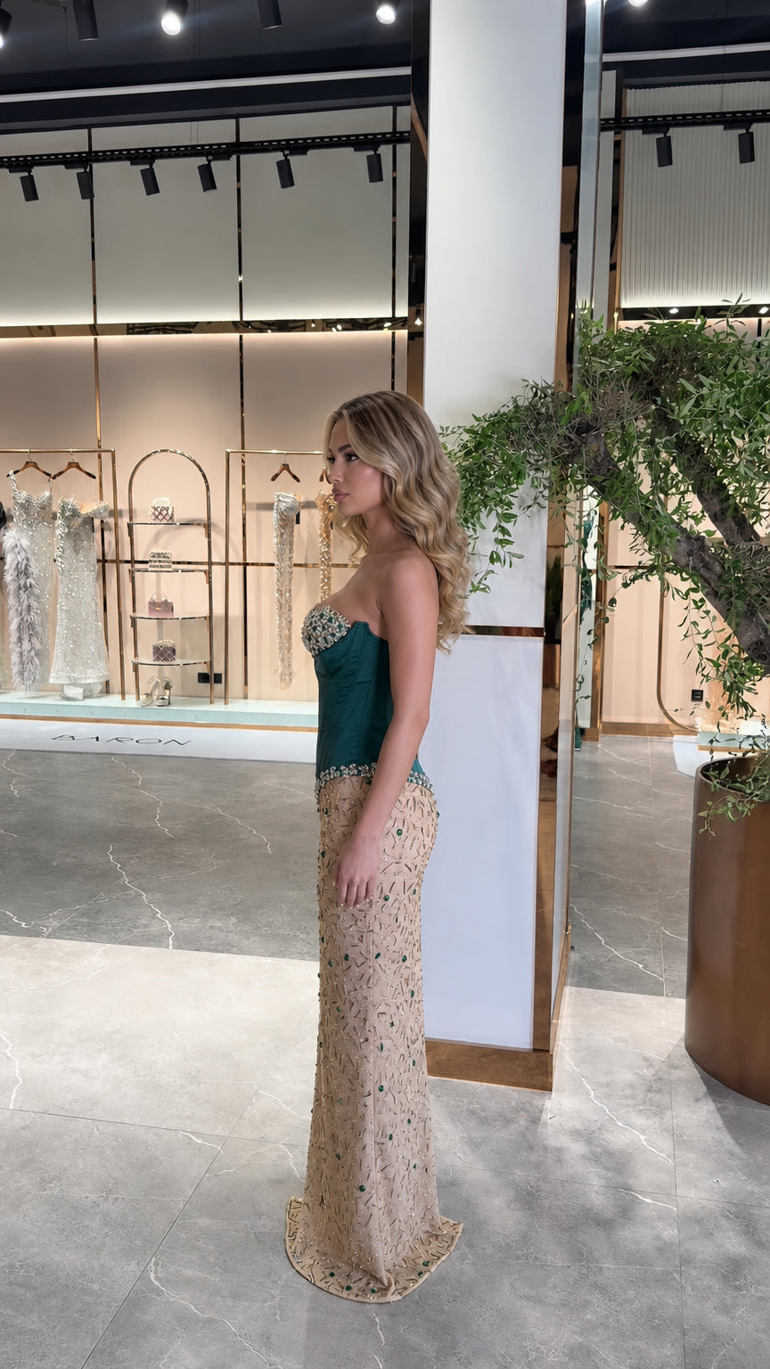 Side profile view of emerald green boned corset formal maxi dress