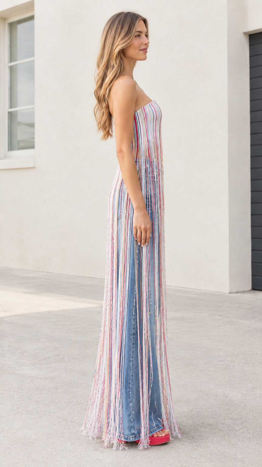Side profile of model wearing strapless striped maxi fringe tube top showing full fringe length