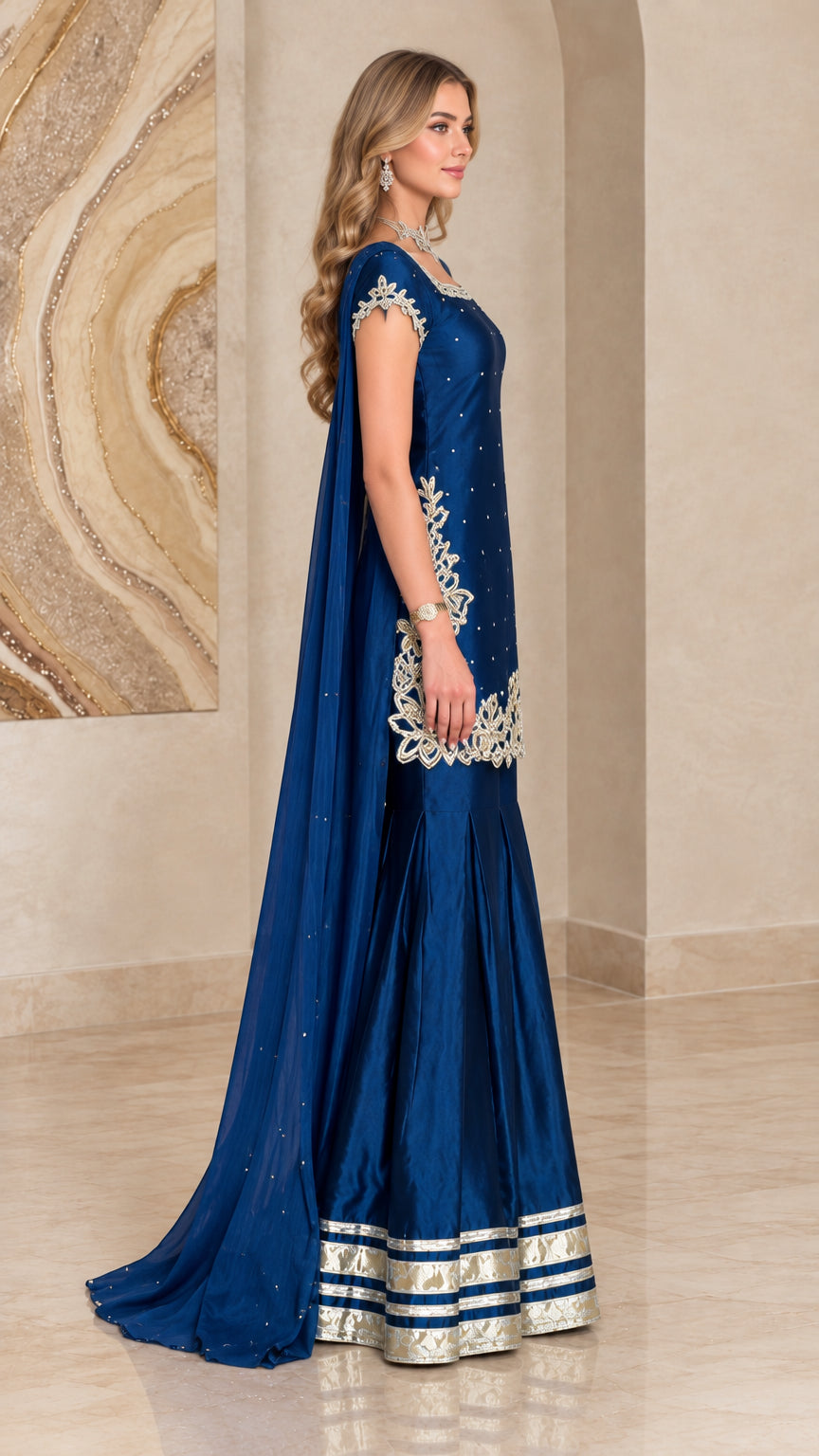 Side profile of royal blue cape sharara suit showing dramatic length