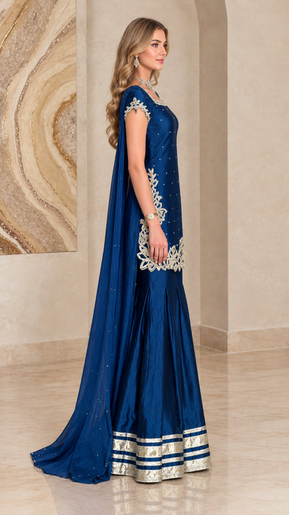 Side profile of royal blue cape sharara suit showing dramatic length