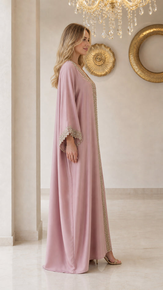 Side view of model wearing flowing dusty pink kaftan maxi dress