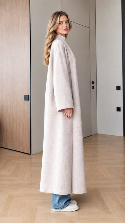 Side profile view of model wearing Oatmeal oversized maxi coat