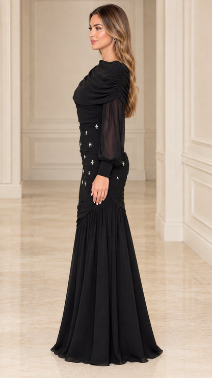 Side profile view of model wearing black long sleeve formal evening gown