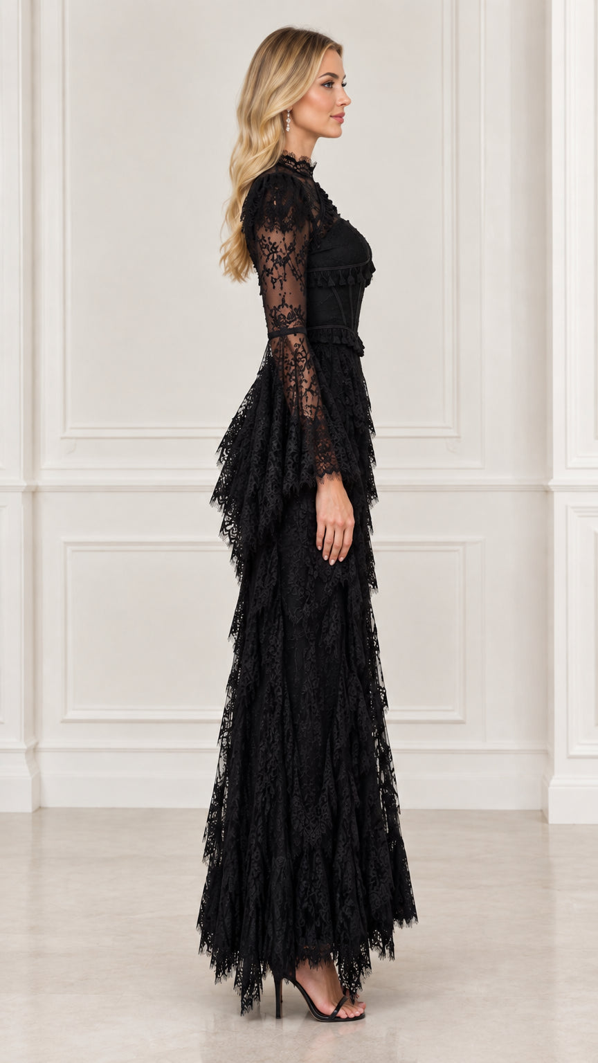 Side view of black long sleeve lace evening dress with tiered fringe maxi skirt