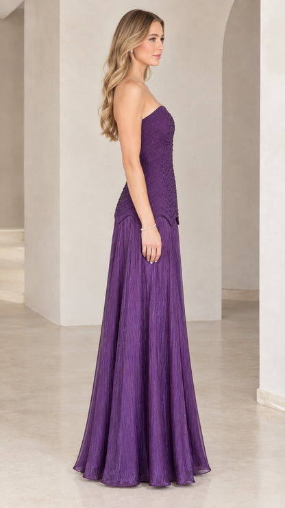 Side profile view of purple strapless beaded evening gown