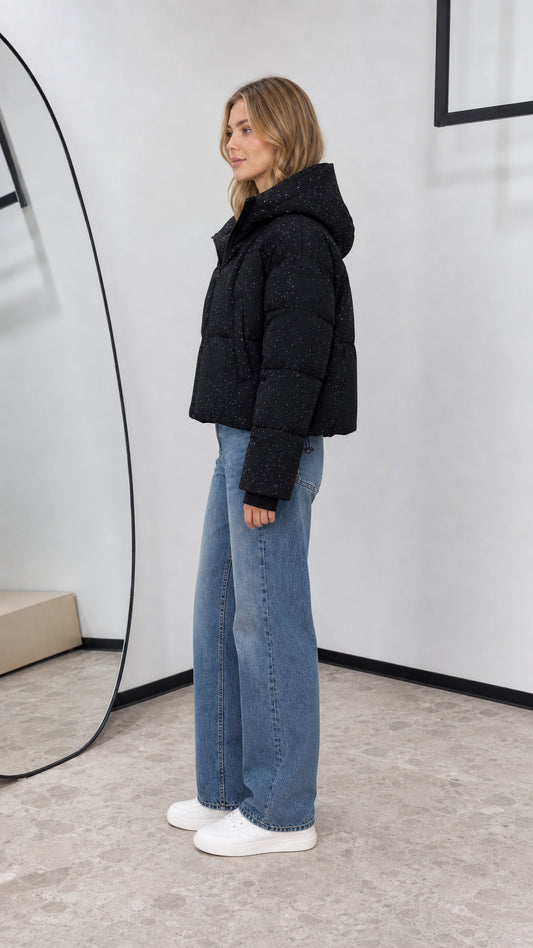 Side profile view of black sparkle cropped quilted bubble jacket