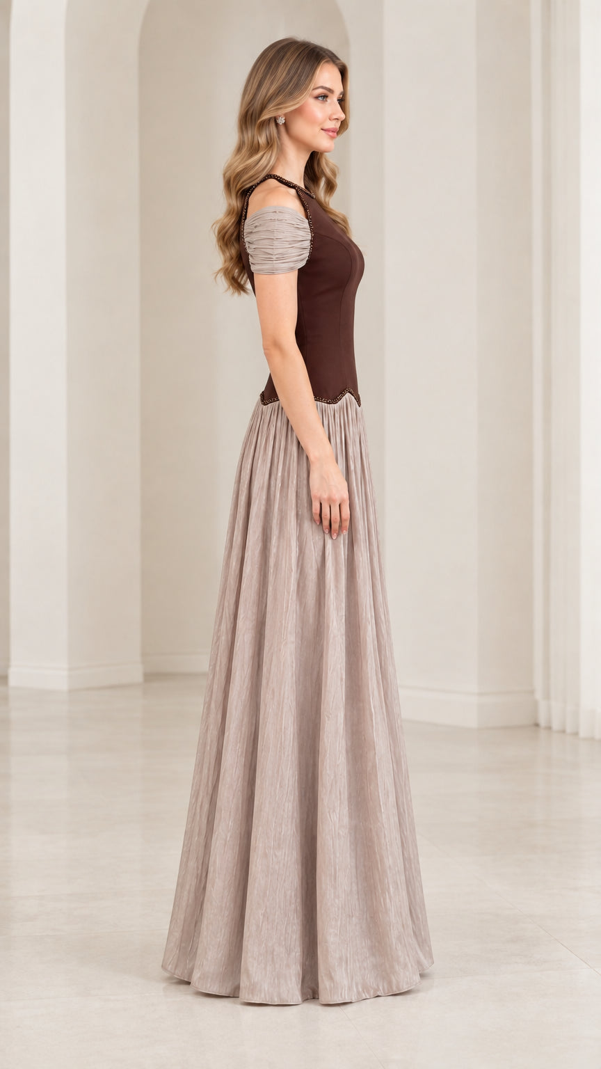 Side profile view of chocolate brown and taupe pleated evening gown