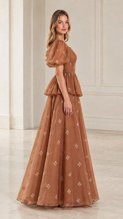 Side profile view of woman modeling toffee brown sheer sleeve formal evening dress