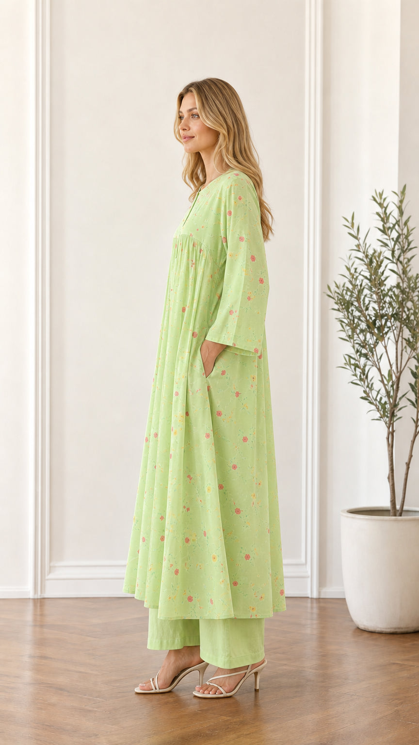 Side profile of woman in light green floral maxi dress showing pocket placement