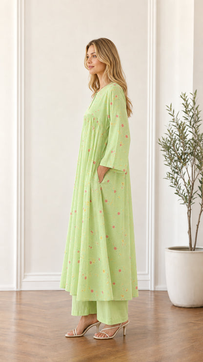 Side profile of woman in light green floral maxi dress showing pocket placement