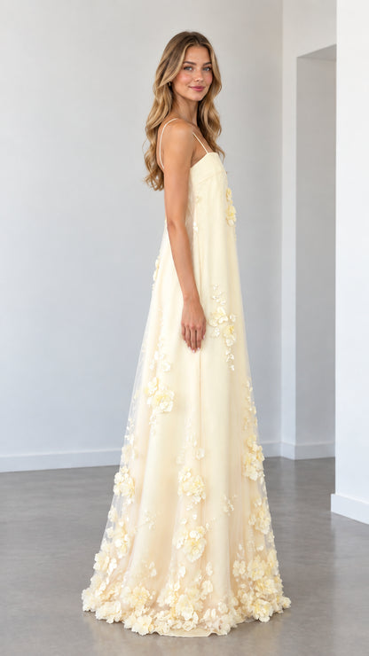 Model wearing butter yellow floral applique A-line gown side view