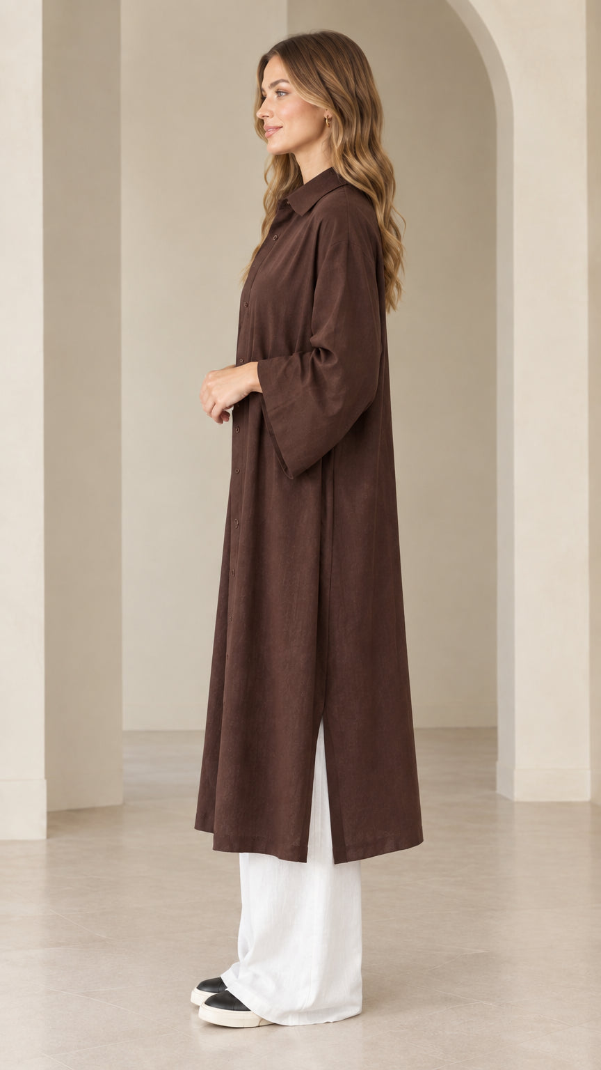 Side view of dark brown duster dress showcasing side slit hem and relaxed fit