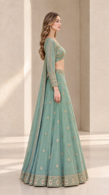 Side profile view of woman wearing sage green long sleeve lehenga choli set