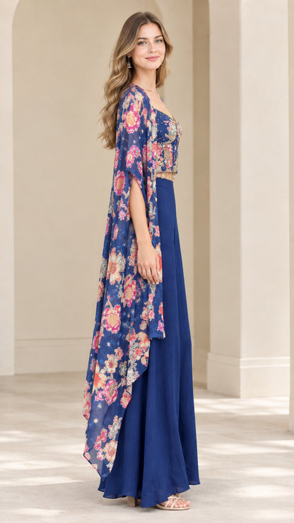 Side profile of royal blue floral print cape and wide-leg trousers