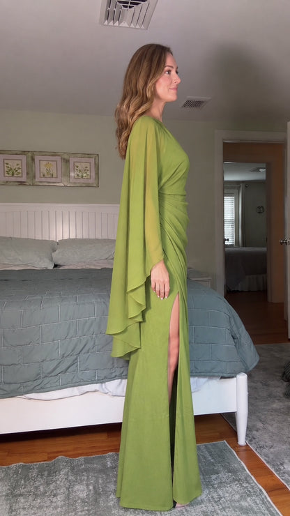 Side profile of olive green one-shoulder gown showing cascading cape sleeve