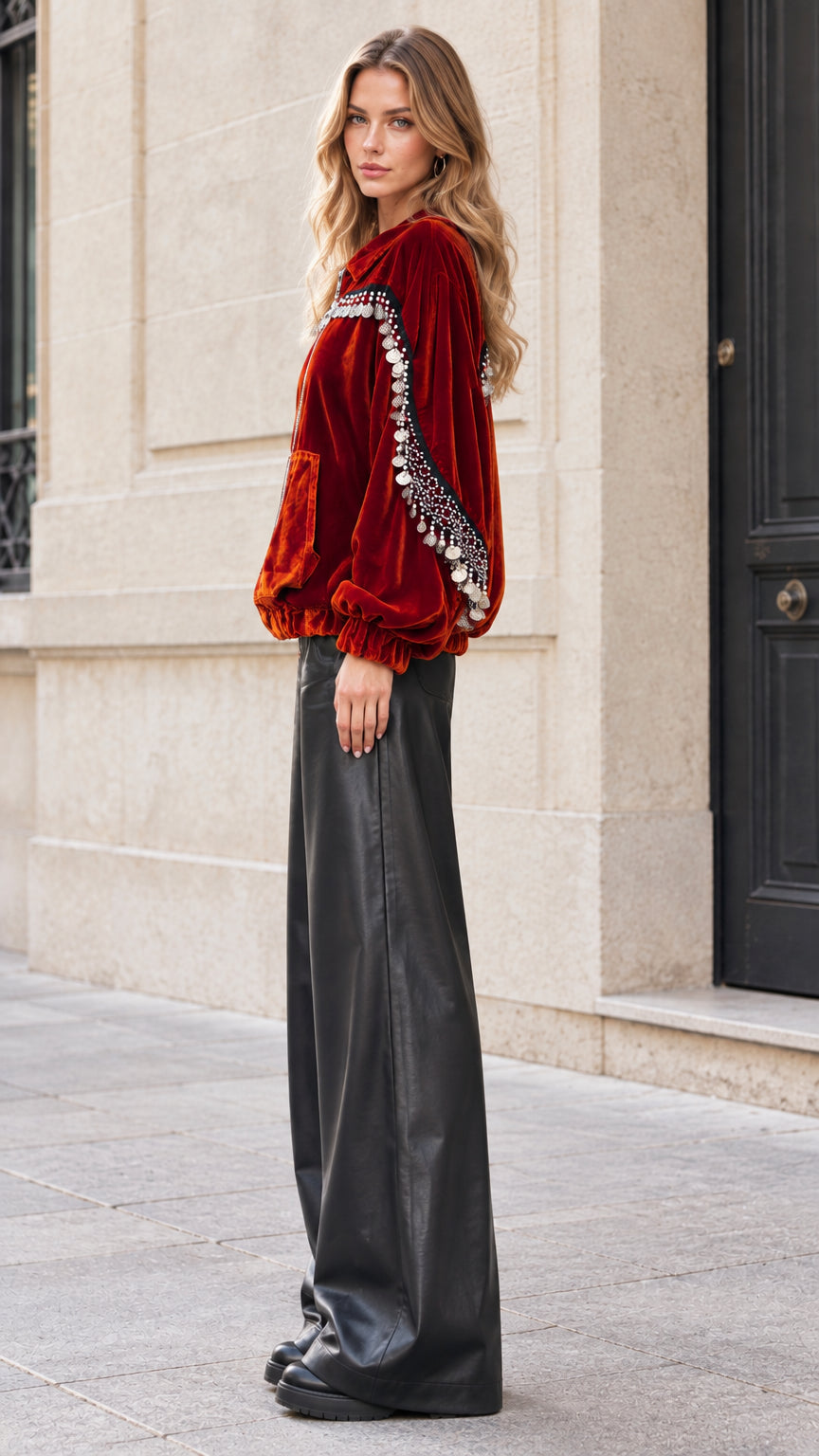 Side profile of model in rust velvet bomber jacket with sleeve coin detailing