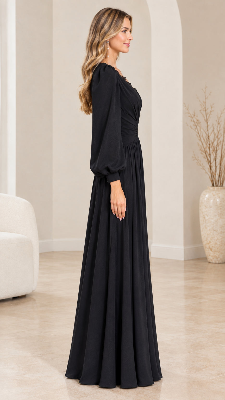Side profile view of elegant black long sleeve maxi gown on model