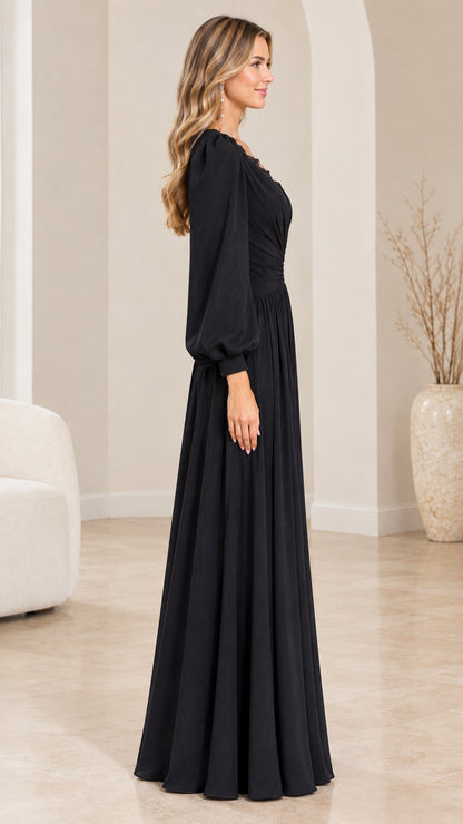 Side profile view of elegant black long sleeve maxi gown on model