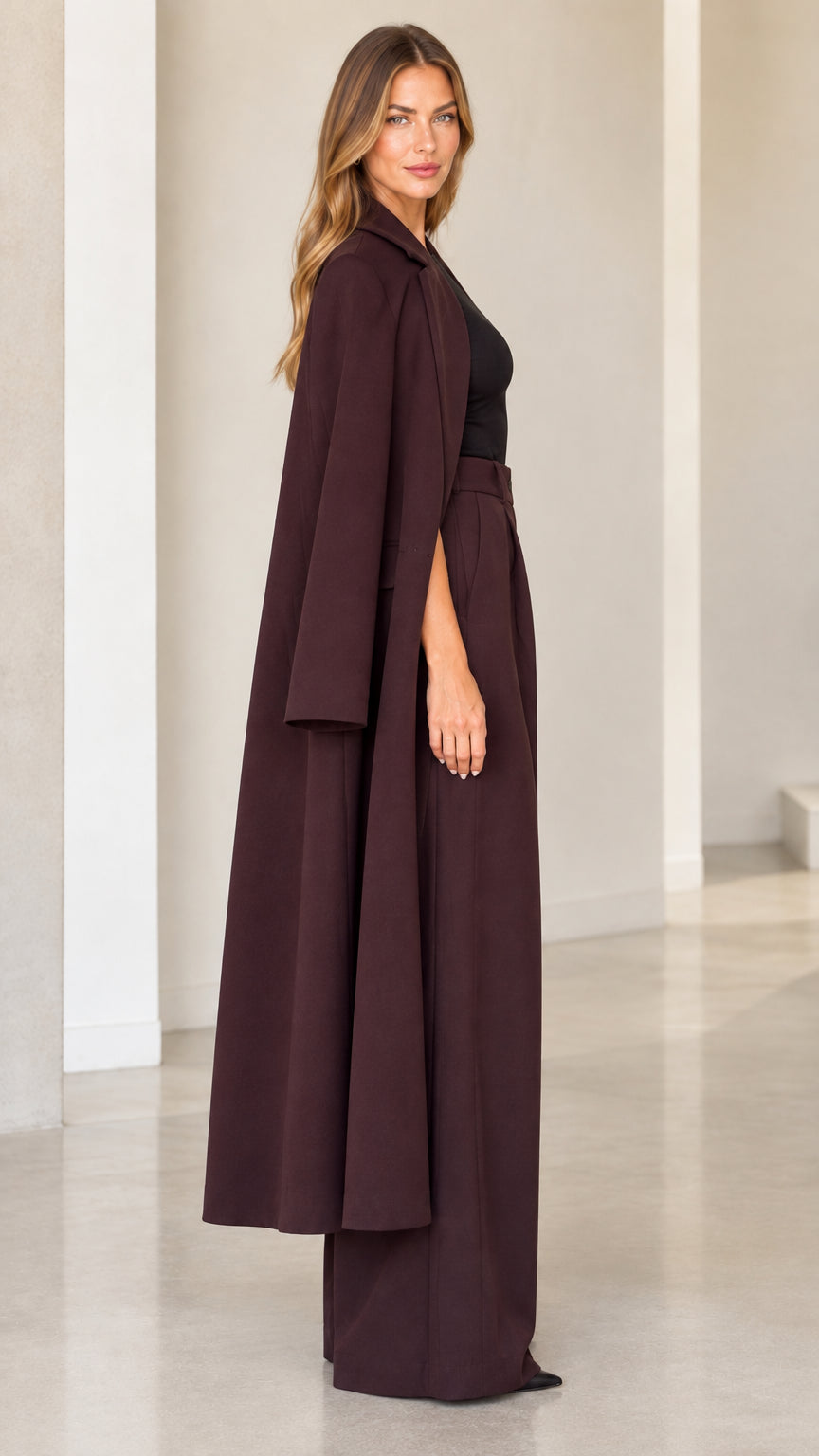 Burgundy cape duster and high waist palazzo pants side profile view