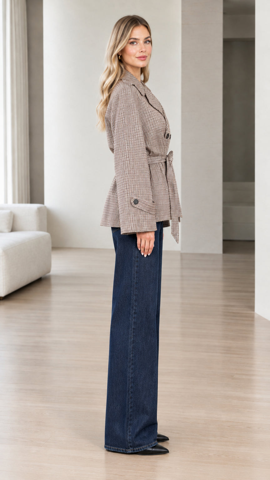 Side profile view of model wearing brown houndstooth belted short coat