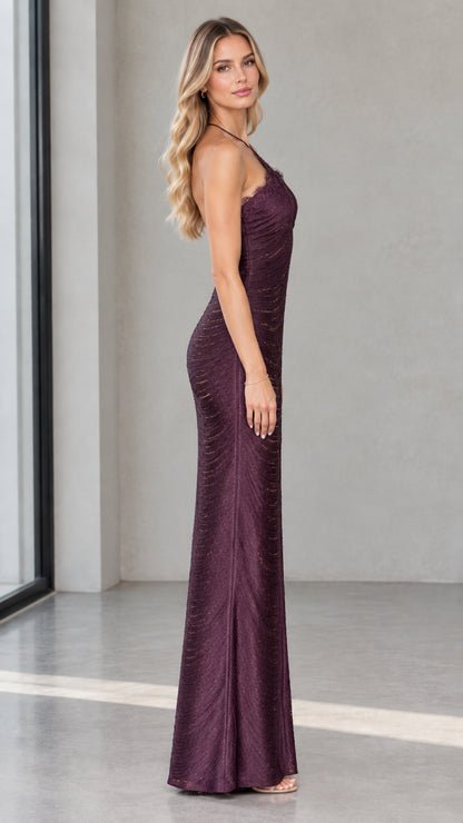 Side profile view of model in Deep Plum halter neck column evening gown