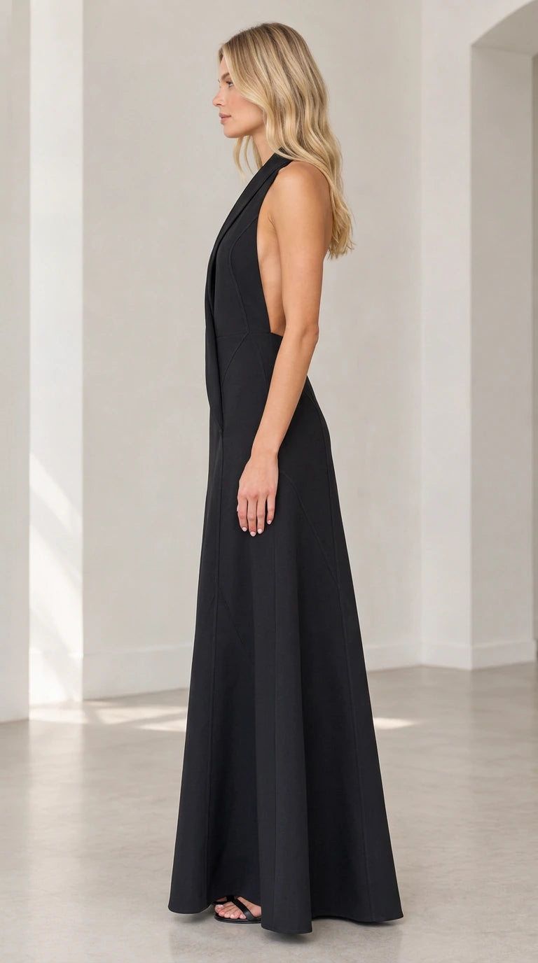 Side profile view of black backless halter formal maxi dress