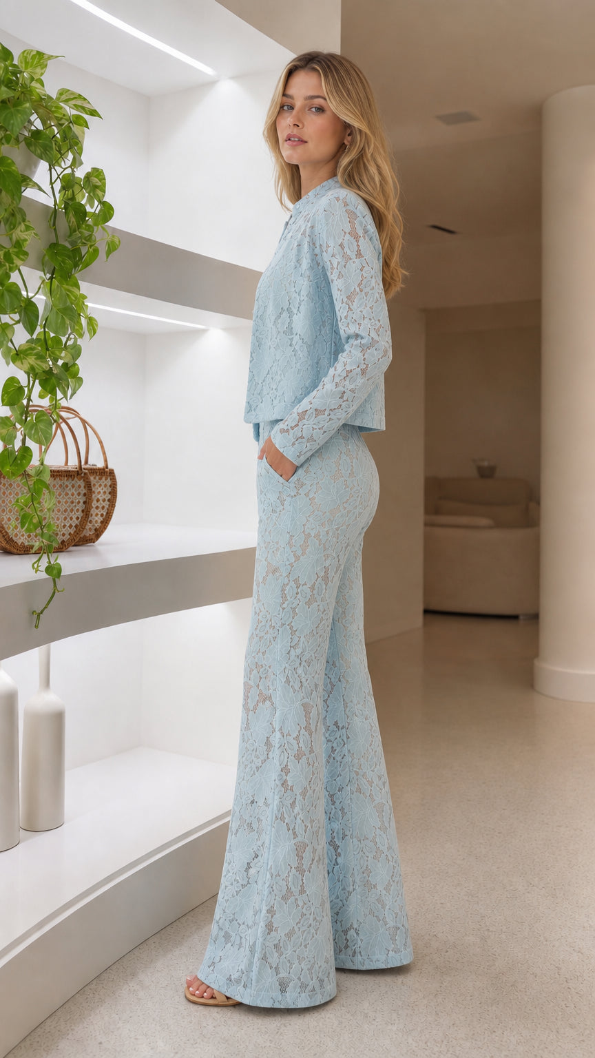 Side view of woman wearing light blue lace blazer and matching wide leg pants