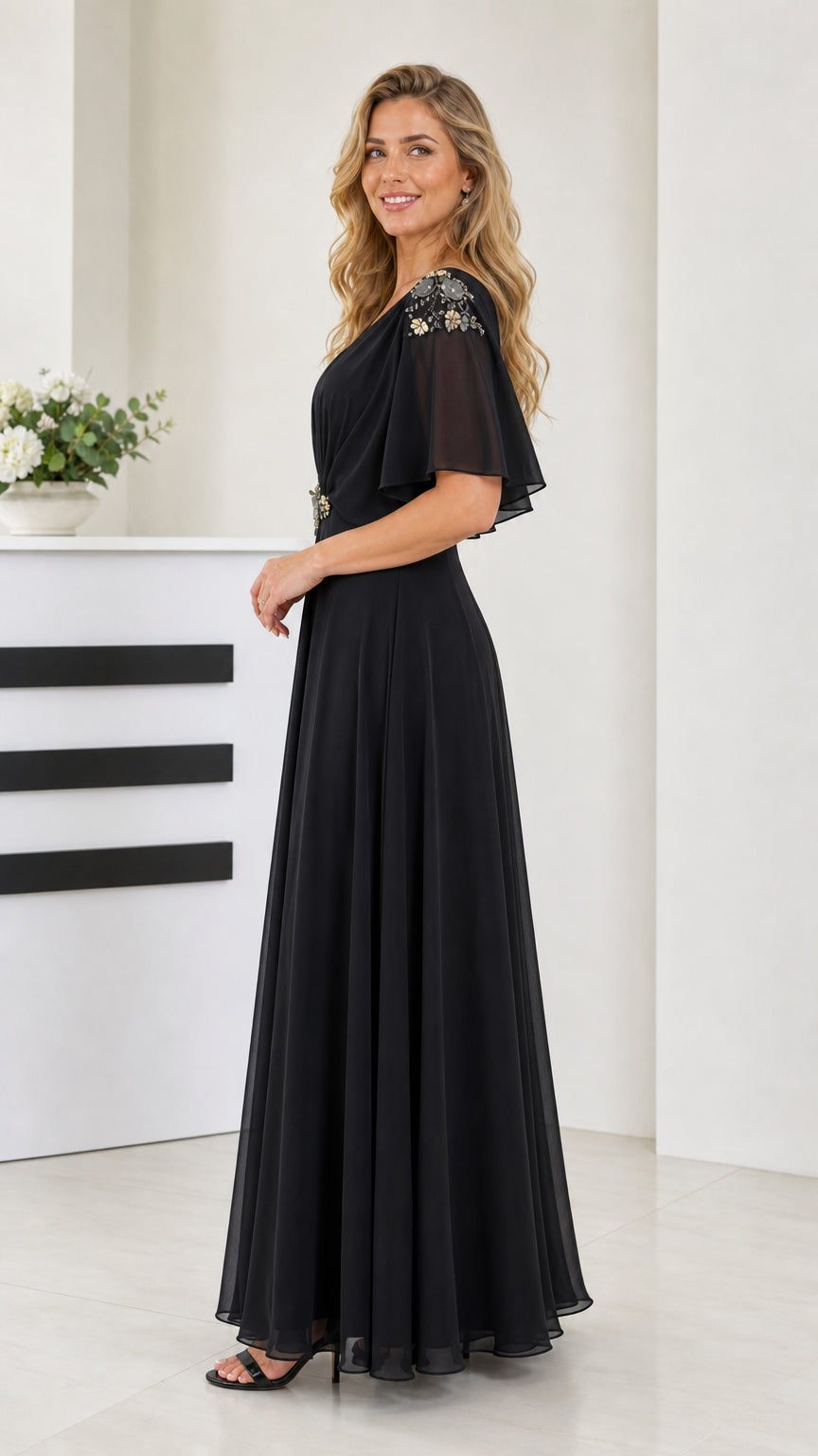 Side angle view of model wearing black long chiffon dress with ruched bodice