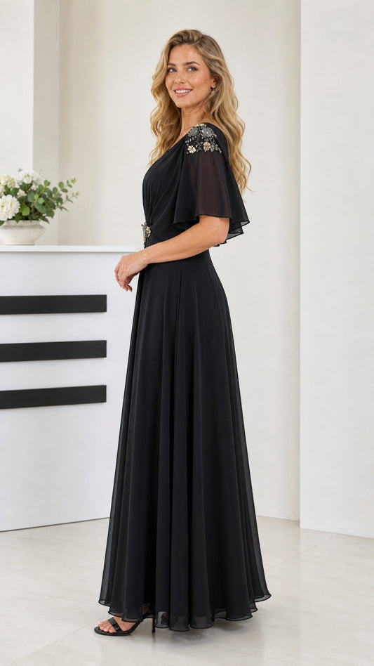 Side angle view of model wearing black long chiffon dress with ruched bodice