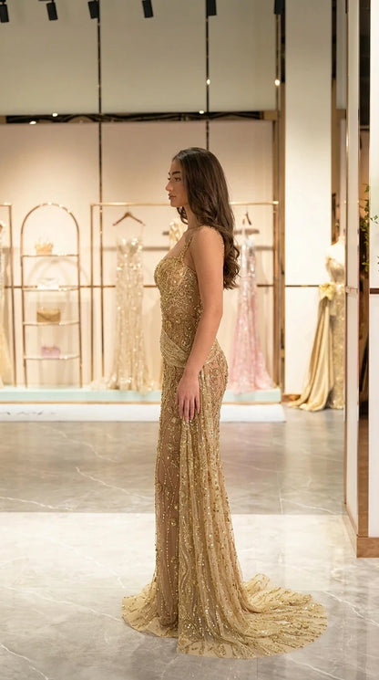 Side profile view of fitted gold sequin formal gown showing silhouette