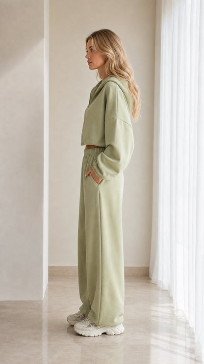 Side profile of model in sage green matching tracksuit set