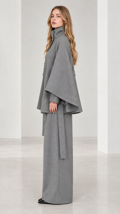 Side profile view of grey belted cape coat and flowy wide-leg trousers set