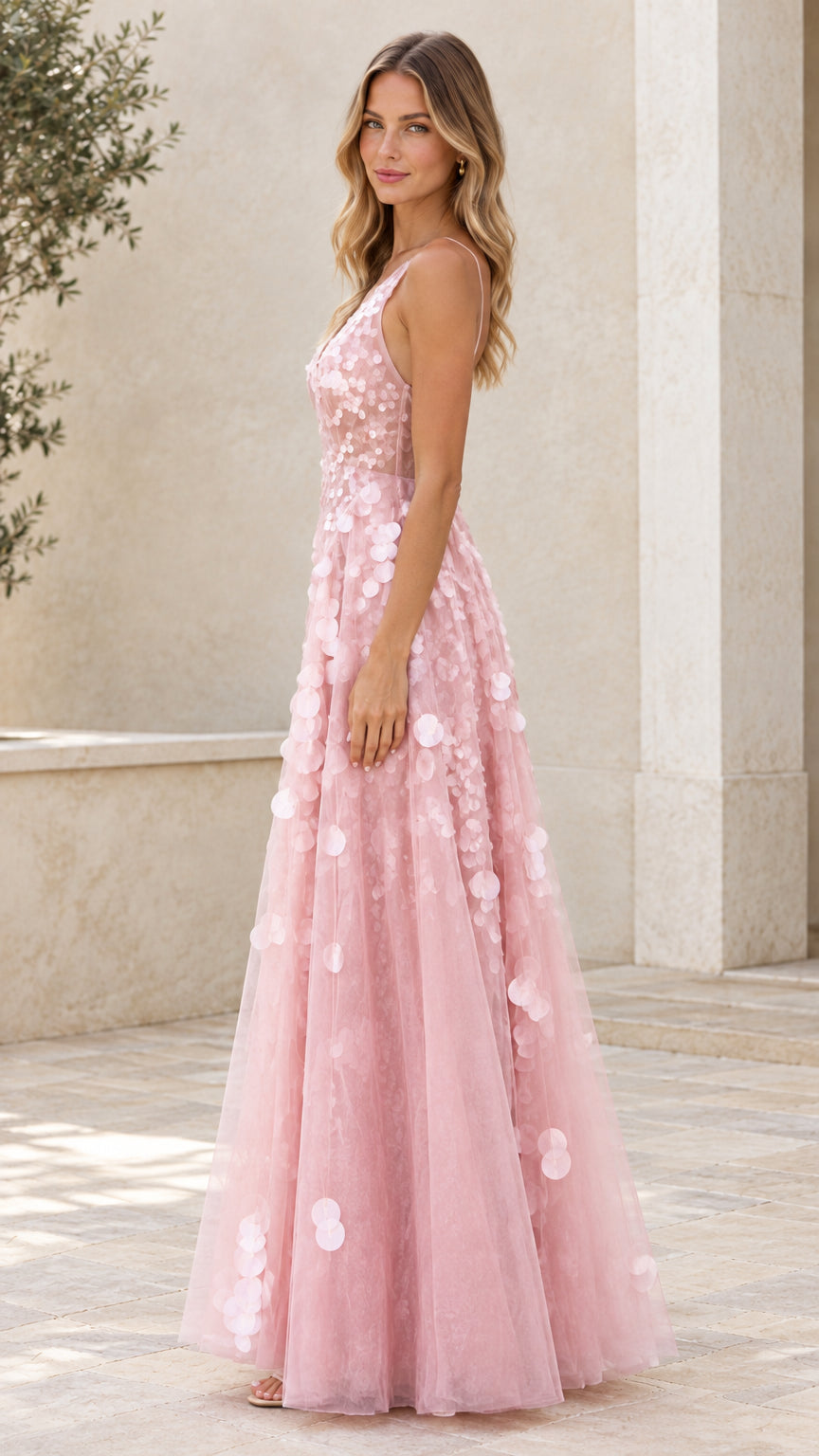 Side view of blush pink A-line tulle formal maxi dress with petal accents