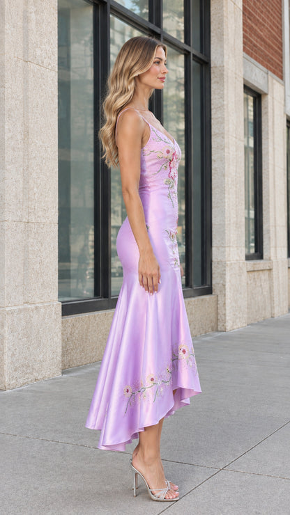Side profile of model wearing lilac embroidered satin midi dress