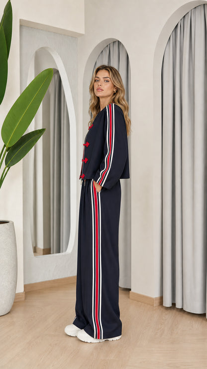 Side angle of model wearing navy blue wide leg tracksuit set