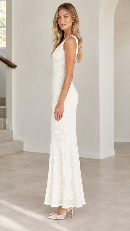 Side profile view of ivory sleeveless lace maxi gown